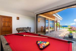 a pool table in a room with a view of the ocean at Magnificent 5 Br Villa with pool: amazing views in Punaauia