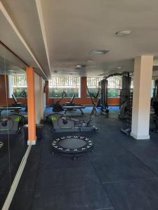 a gym with several treadmills and exercise bikes at Resort Ondas Praia apart in Porto Seguro