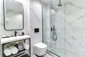 a bathroom with a shower and a toilet and a sink at AboV Athens in Athens