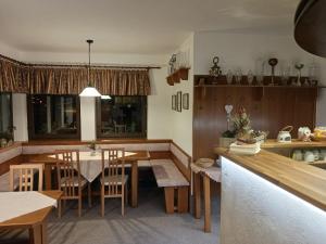 a kitchen and dining room with a table and chairs at Pension Ploc in Harrachov