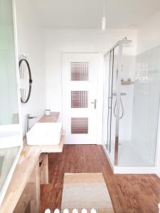 a white bathroom with a sink and a shower at Loue maison 10 couchages à La Rochelle avec jardin, proche plage in La Rochelle