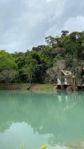 a body of water with a house in the middle at Chalés da Floresta in Porto Seguro
