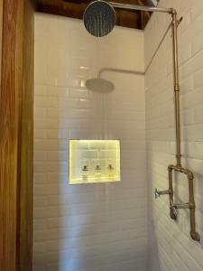 a bathroom with a shower with a light at Casa 1800 Los Naranjos Boutique Hotel in Los Naranjos
