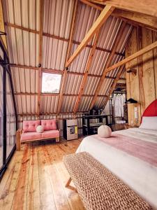 Dormitorio con cama y banco en un granero en Casa 1800 Los Naranjos Boutique Hotel, en Los Naranjos