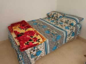 a bed with a floral pattern on it at Hurghada Marina in Hurghada