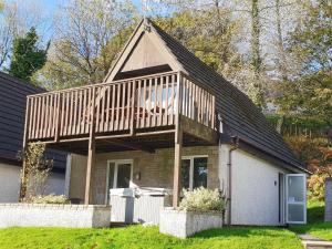 a house with a wooden deck on top of it at Valley Lodge 47 - Ukc2779 in Gunnislake