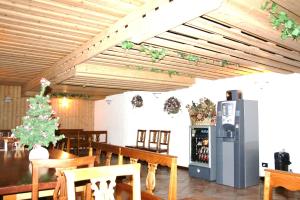 a dining room with a christmas tree and a refrigerator at Residence Mirelladue in Ponte di Legno