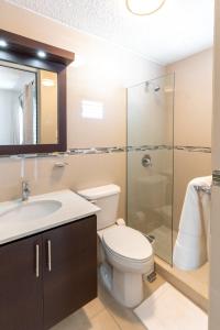 a bathroom with a toilet and a sink and a shower at Aquaville Dorado Moderna Villa 2 in Dorado
