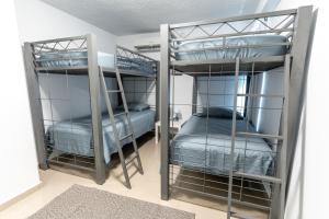 a room with two bunk beds in a room at Aquaville Dorado Moderna Villa 2 in Dorado