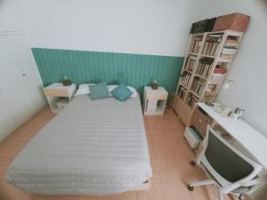 a bedroom with a large bed and a television at Crespo Urbano in Buenos Aires