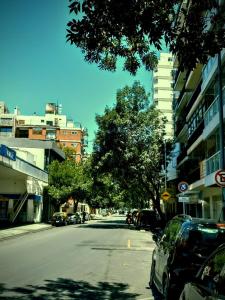 a street with cars parked on the side of the road at Crespo Urbano in Buenos Aires