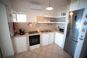 a small kitchen with a sink and a stove at Costa dei Monaci Villas - Tropea in Parghelia