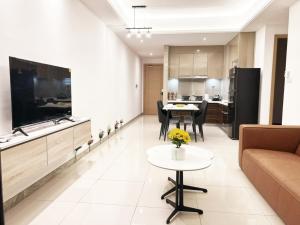 a living room with a couch and a table at R&F Princess Cove by GreatDay in Johor Bahru