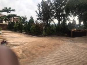 an empty yard with trees and a house at Nuc-Fey Lodging in Kigali