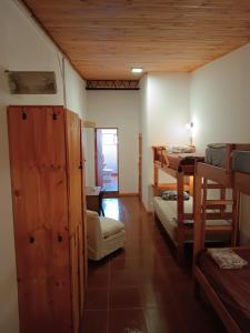 a room with three bunk beds and a table at Cataratas Jazz Hostel in Puerto Iguazú