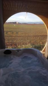 a bath tub with a view of a field at Le Spa des lavandes in Valensole