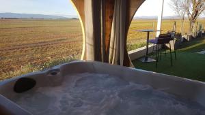 a bath tub with a view of a field at Le Spa des lavandes in Valensole