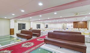 a banquet hall with chairs and tables in a room at Treebo Trend SK Suites in Bangalore