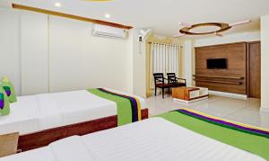 Treebo Skanda Suites客房内的一张或多张床位