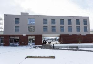 a building with snow in front of it at Residence Thessoni Home , Boarding house & serviced apartments Z&uuml;rich in Regensdorf