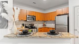 a kitchen with a counter with two bowls on it at “Essence” Condo in Buckhead in Atlanta