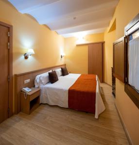 A bed or beds in a room at Hotel Ripoll