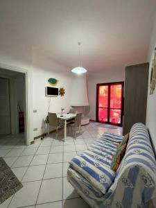 a bedroom with a bed and a table in a room at Residenza ICHNUSA in Villasimius