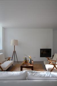 a living room with a couch and chairs and a table at A Padaria Farmhouse in Cinfães