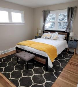 a bedroom with a large bed and two windows at The Brickhouse in Pocatello
