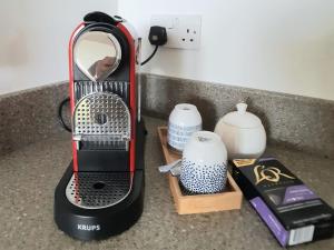 a black and red blender on a counter with other items at The Fold in Appleton