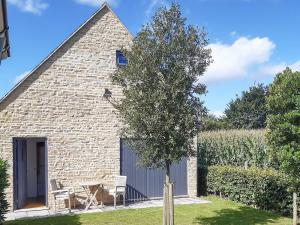 a small stone cottage with a tree in the yard at The Fold in Appleton