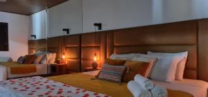 a bedroom with two beds and a large headboard at Pousada Descobrindo a Vida in Brumadinho