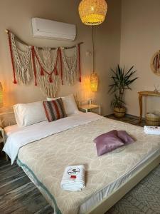 a bedroom with a large bed with towels on it at Hera Hotels Alaçatı in Cesme