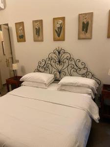 a bedroom with a large white bed with white pillows at 3House in Rome