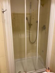 a shower with a glass door in a bathroom at 3House in Rome