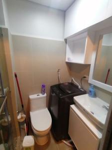 a small bathroom with a toilet and a sink at Cosy Luxy Coast Residences Staycation in Manila