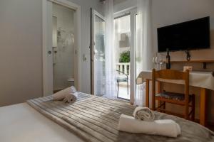 a bedroom with a bed with towels on it at Villa Sladojević in Omiš