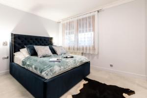 Posteľ alebo postele v izbe v ubytovaní Apartament Szafir - Viva pod Giewontem Apartamenty
