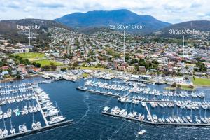 an aerial view of a marina with boats in the water at King Bed, Water Views, Private Parking, Courtyard Living in the Heart of Sandy Bay in Sandy Bay