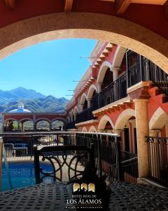 a view of a building with a bridge and a table at Hotel Real de los Alamos in Álamos