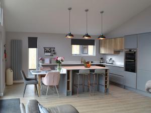 a kitchen with a island and a table with chairs at The Bunker in Otterburn