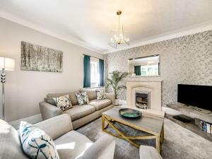 a living room with a couch and a fireplace at North Lodge Cottage in Chester-le-Street