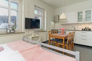 a kitchen and dining room with a table and chairs at Ośrodek WOJKÓW Kowary koło Karpacza in Kowary