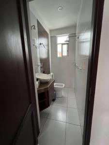 a bathroom with a toilet and a sink and a mirror at Comfy apartment, best location ! in Tarija +10 photos