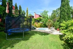 a swing in a yard with a pool at Chalet Navacerrada Piscina Privada in Navacerrada