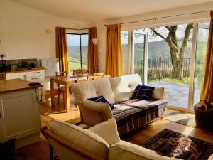 a living room with a couch and a table and a kitchen at The Platt in Dunterton