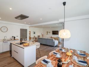 een keuken en een woonkamer met een tafel en stoelen bij 33 Cliff Edge in Newquay