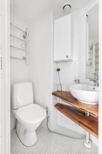 a bathroom with a white toilet and a sink at WeHost Heart of Helsinki Studio with Top Amenities in Helsinki