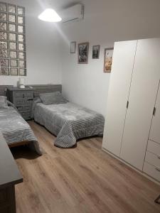 - une chambre avec 2 lits et une commode dans l'établissement Apartamentos EL PELIGRO, à Archidona
