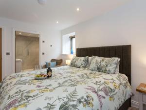 a bedroom with a bed with a bowl of fruit on it at The Barn At Toft Hill Hall in High Etherley